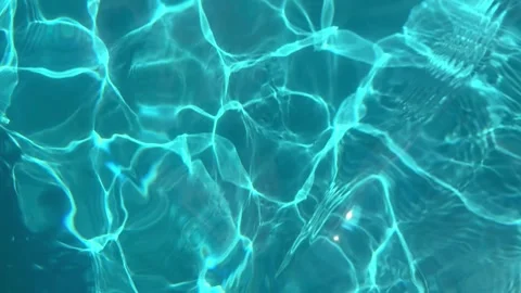 Abstract reflections on a blue swimming pool during daylight in the summer Stock Footage 315924455