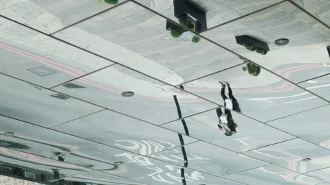 Abstract reflections in a mirror of people walking, modern urban environment 스톡 동영상 128839791