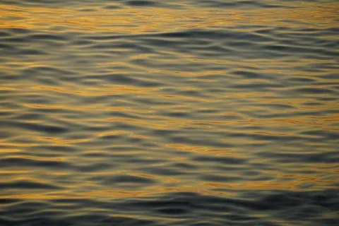 Abstract representation of the sea surface in gray and yellow parallel lines Stock Photos