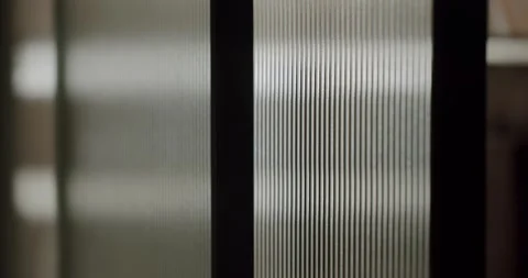 Abstract ribbed glass moving with light reflection and distortion Stock Footage 345543730