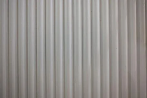 Abstract ribbed texture.  Neutral gray tones create a subtle, vertical patter Stock Photos
