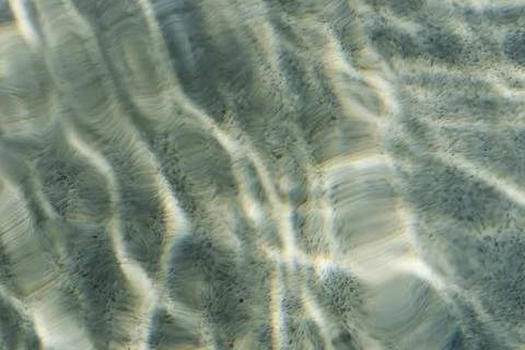 Abstract ripple water pattern in a swimming pool with sun reflection Stock Photos