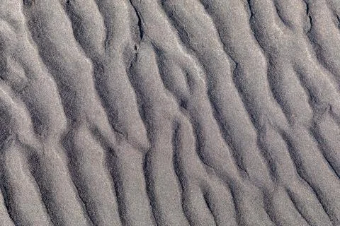 Abstract rippled sand texture background with natural wave patterns and shadows Stock Photos