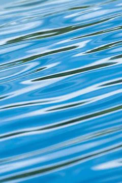 Abstract ripples waves on surface of blue water. Stock Photos