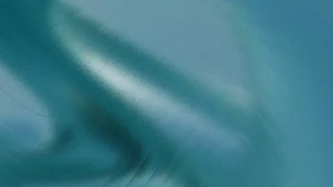 Abstract rippling deep blue teal textured background with subtle illuminate.. Illustrazione stock