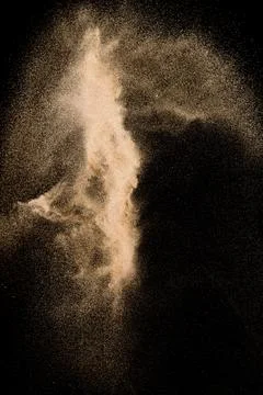 Abstract river sand cloud. Golden colored sand splash against black backgro.. Stock Photos