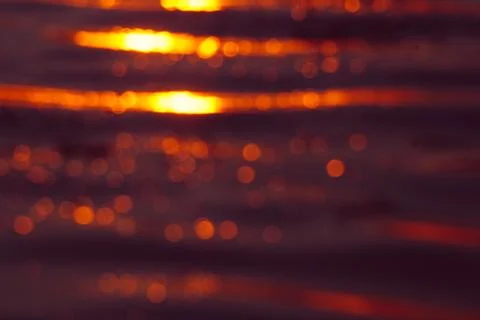 Abstract romantic background, waves at sunset in defocus Stock Photos