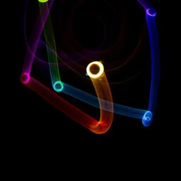 Abstract rotating neon lights texture with black empty copy space inside. col Stock Photos