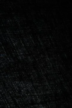 Abstract rough dark background of linen natural fabric on the light, short fo Stock Photos