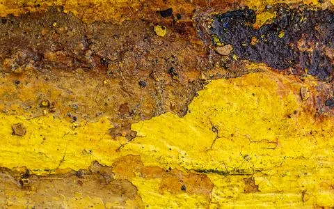 Abstract rusty metal texture in aged yellow paint closeup Stock Photos