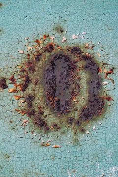 Abstract rusty texture with a cracked green paint and a large rust stain in t Stock Photos