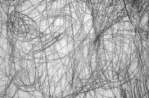 Abstract scribble, scrawl by pencil on the gray wall as texture or background Stock Photos