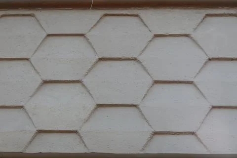 Abstract seamless geometric pattern of cement hexagon tiles on wall facade Stock Photos