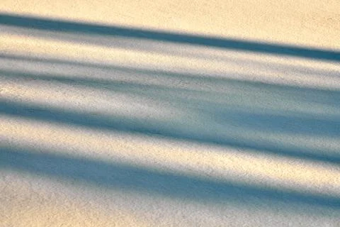 Abstract shadow lines on winter snow background Stock Photos
