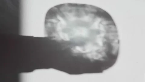 Abstract shadow of a magical glowing crystal on a white wall. Silhouette of Stock Footage 147329080