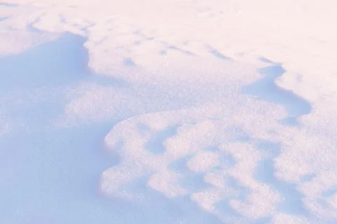 Abstract shadow natural patterns on blue and pink snow in morning sunlight Stock Photos
