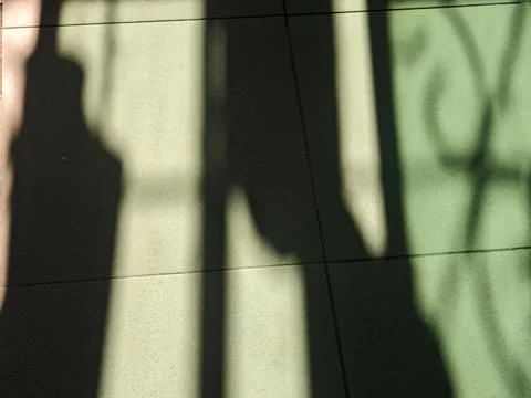 Abstract Shadow Patterns on Green Floor Tiles Stock Photos
