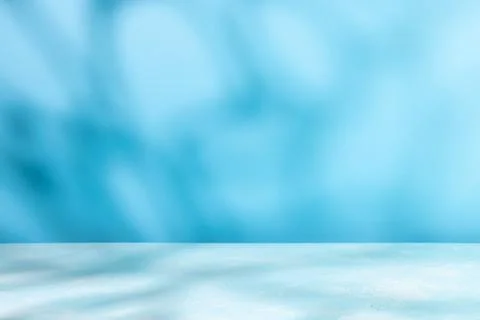 Abstract shadow on table top and blue wall background. Blurred backdrop wit.. Stock Photos