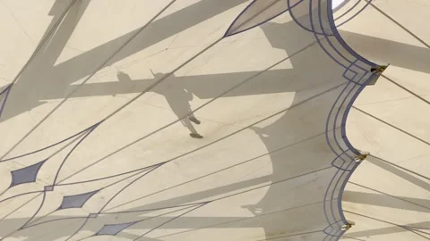 Abstract Shadow of Worker on Giant Retractable Umbrella Canopy Vídeo Stock 320436949