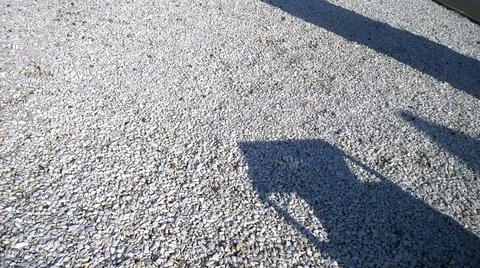 Abstract shadows on rubble on the ground. Construction materials background. Stock Photos