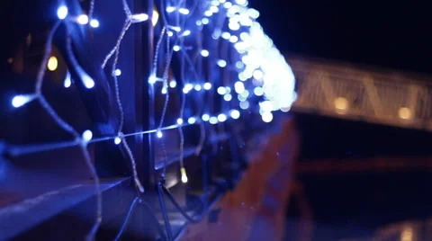 Abstract shallow depth of field blue lights on a railing over water Stock Footage 49413588