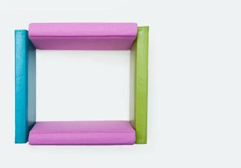 Abstract shape of square made up of four books over white background Stock Photos