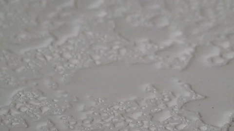 Abstract shapes, patterns and textures of raindrops and droplets on a white Stock Footage 291556949
