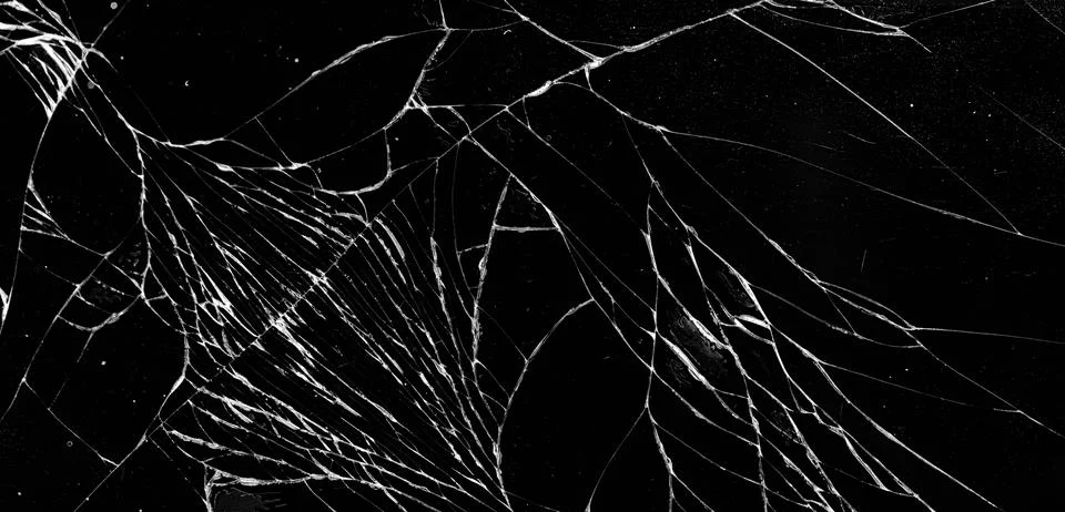 Abstract shattered glass web pattern macro view on dark background Stock Photos