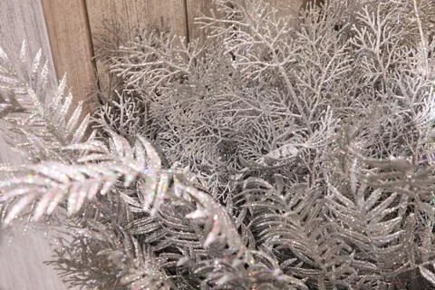 Abstract shimmering silver background of decorative branches with bokeh effec Stock Photos