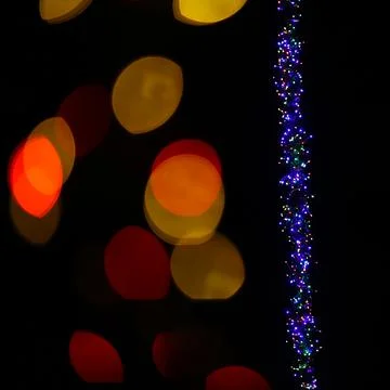 Abstract shot of string lights becoming blurry color spots Stock Photos