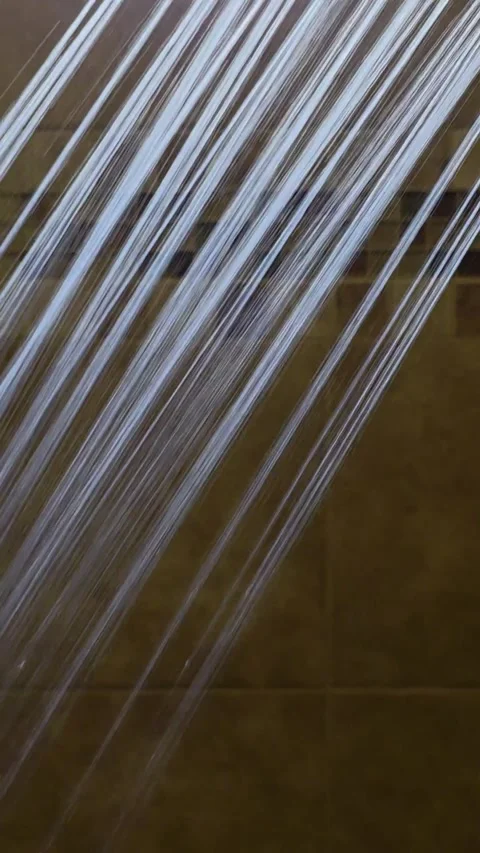 Abstract Shower Water Streams Flowing on Brown Tiled Bathroom Wall Close Up Stock Footage 336639507