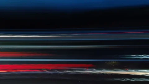 Abstract side view of car light trails moving fast at night time lapse Stock Footage