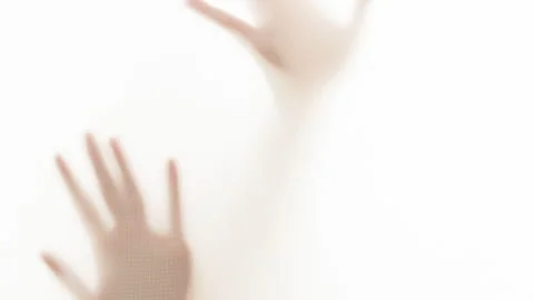 Abstract silhouette of a hand on a white background behind a silk fabric  Stock Footage 262058053