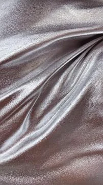 Abstract silver metallic fabric with dynamic folds. Shiny, flowing material.. Stock Photos