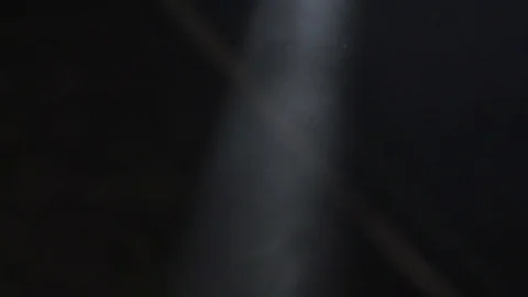 Abstract - Slow motion Dust and Smoke entering into light Stock Footage 73528897