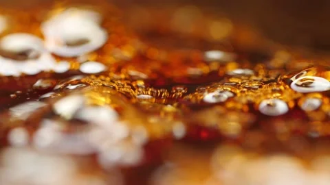 Abstract slow motion shot of bubbles in boiling amber color thick liquid. Stock Footage 158478842