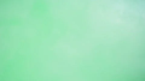 Abstract smoke on green chroma key background. Smoking, steam clouds close-up. Stock Footage 181999241