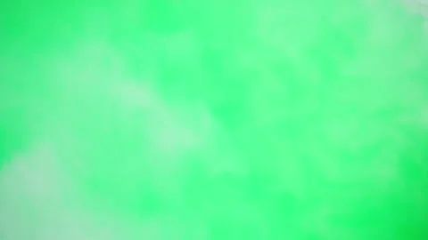 Abstract smoke on green chroma key background. Smoking, steam clouds close-up. Видео 182007981