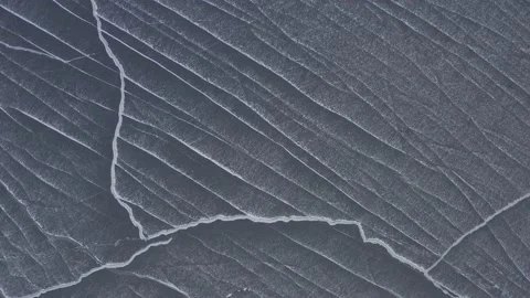 Abstract snow drift lines on lake of ice Ascending aerial view Stock Footage 146730505