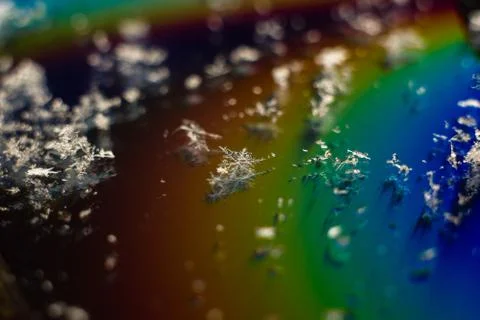 Abstract snowflake on the colored background Close-up. Macro photograph snowf Stock Photos