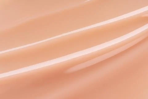 Abstract soft beige fluid texture with flowing lines and glossy finish. Minim Stock Photos