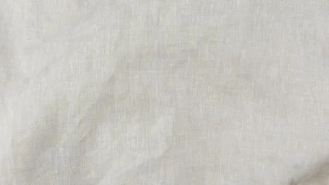 Abstract soft beige linen background. Flowing natural linen fabric in neutral Stock Footage 313156220