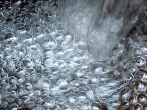Abstract soft whirl of bubbles in a clean flowing stream. Stock Photos