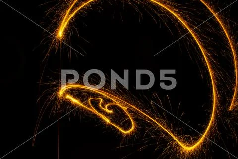 Abstract sparkler firework light on black background Stock Photos