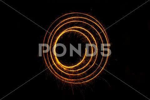 Abstract sparkler firework light on black background Stock Photos