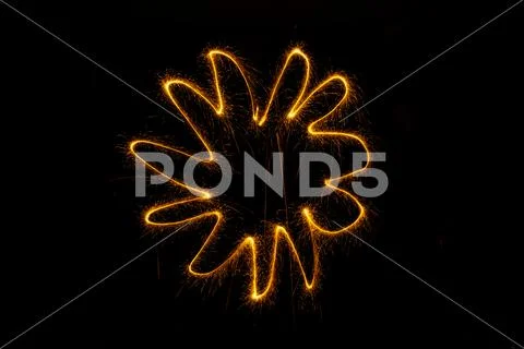 Abstract sparkler firework light on black background Stock Photos