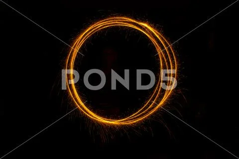 Abstract sparkler firework light on black background Stock Photos