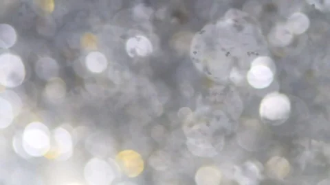 Abstract sparkles or glitter lights. Defocused circles bokeh or particles. Lo Stock Footage 82500153