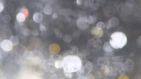 Abstract sparkles or glitter lights. Defocused circles bokeh or particles. Lo Stock-Footage 82500446