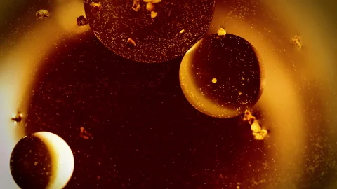 Abstract sparkling orange orbs float and merge macro background texture Video stock 130928349